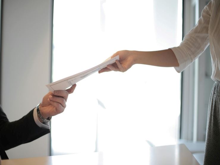 Application being handed to a person.