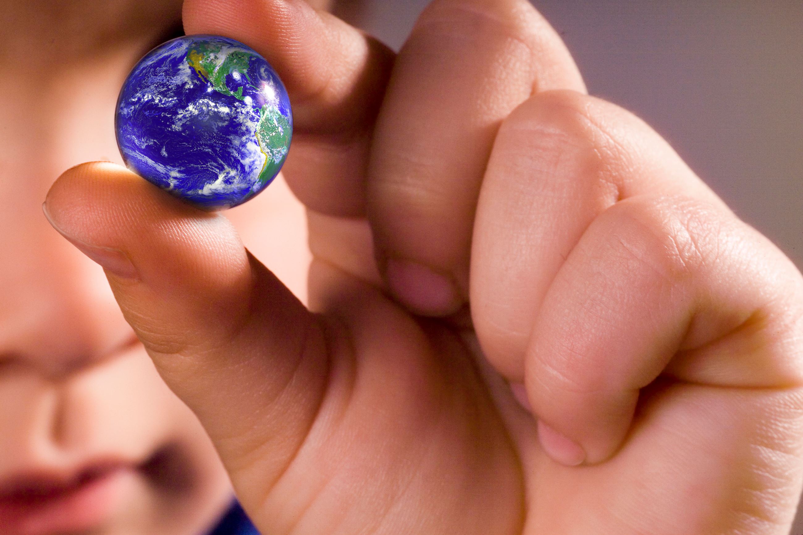 kids hand with earth